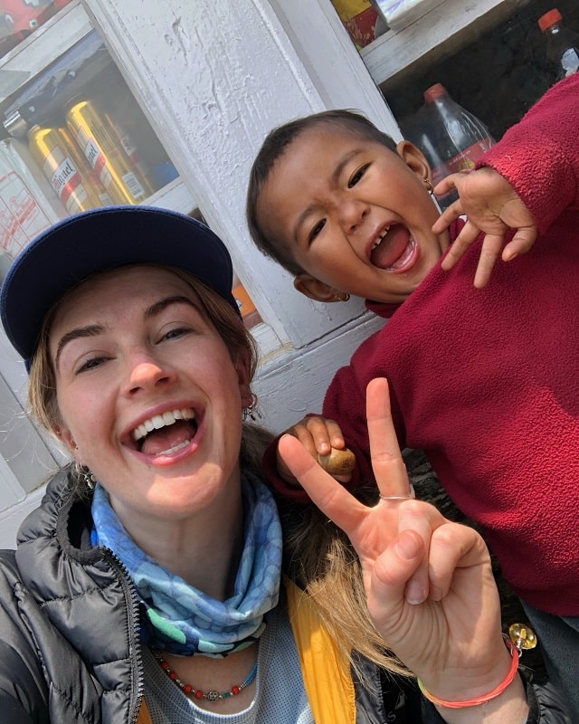 Claire Mackay selfie with a mischievous Sherpa child just out of Lukla