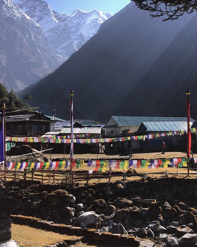 The colourful view of prayer flags as you reach the town of Kothe