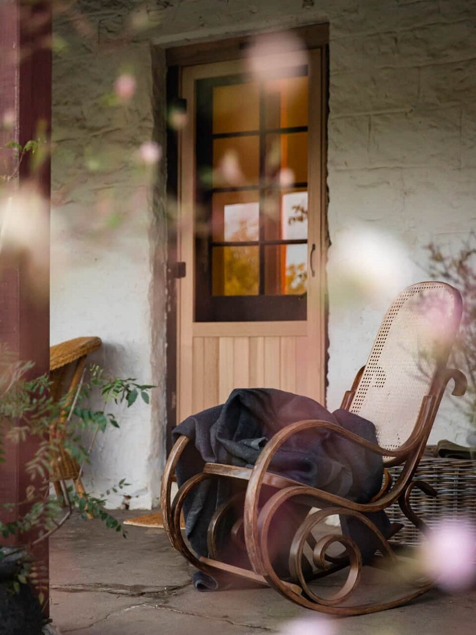 Wooden rocking chair by the front door of The Old Cobbin Homestead Wooden rocking chair by the front door of The Old Cobbin Homestead