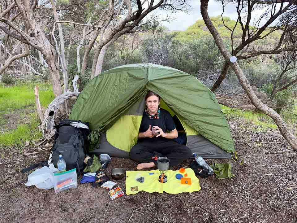 Tom Lucey in the Geo 2-Person Tent preparing a meal