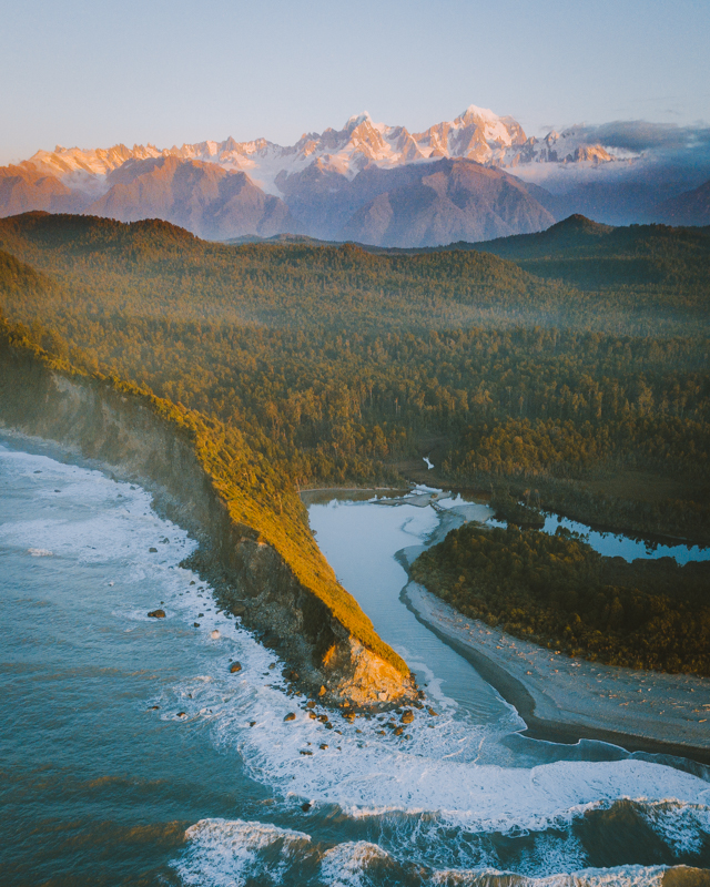 A Drone Shot Of The Wild Coastline With The Southern Alps In The Background A Drone Shot Of The Wild Coastline With The Southern Alps In The Background