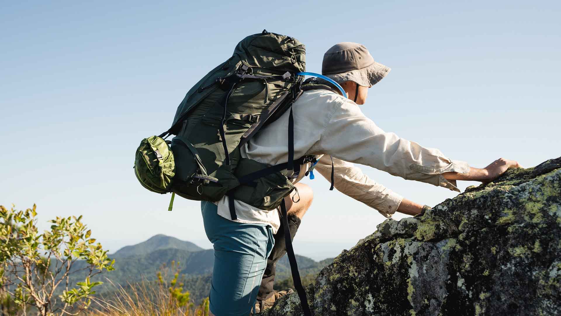 Jack Schmidt climbing rocky terrain with a X-Country 65L Technical Hiking Pack